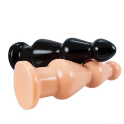 Plug anal de tripla inserção nas cores preto e pele, lado a lado