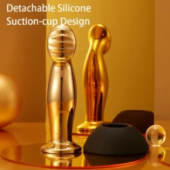 Plug anal dourado ao lado da ventosa de silicone removível