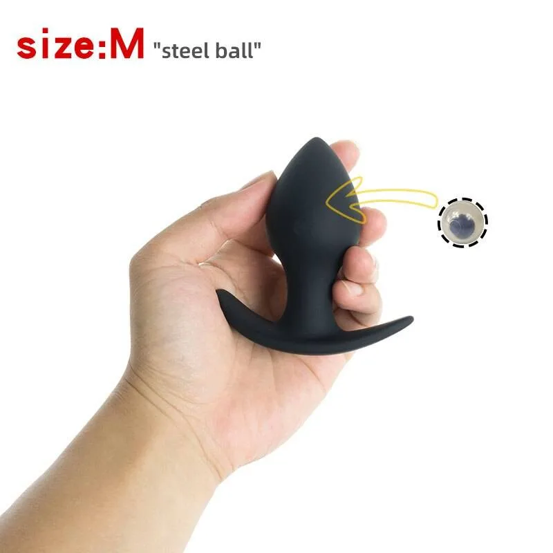 Plug anal pêssego com a esfera de aço visível dentro do corpo de silicone