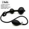 Plug anal inflável preto de dois bulbos com pera de bombear e medidas do modelo Huge Dildo